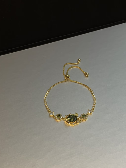 Gold Tone Emerald Accent Slider Bracelet