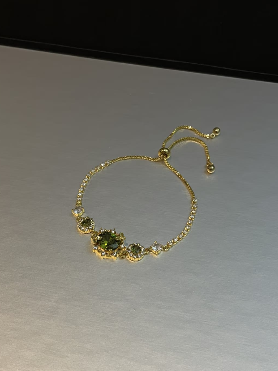 Gold Tone Emerald Accent Slider Bracelet